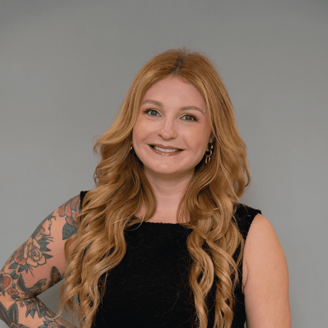 Portrait of Jenni W., a professional stylist at The Changing Room Salon, showcasing their expertise and style.